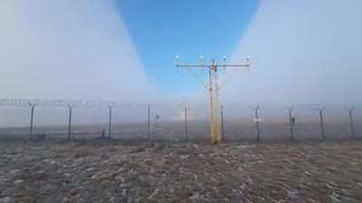 Plane flies through a fog and creates a canyon of a clear sky