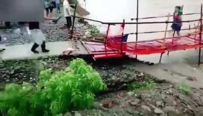 Woman just made it across failing bridge.