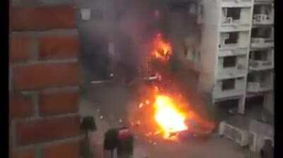 A car which is already on fire explodes. Dhaka, Bangladesh early 2000s
