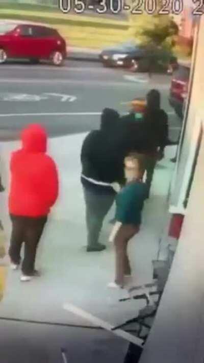 Small white woman trying to stop a BLM protester from destroying her business.