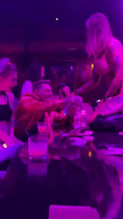On stage mixing a drink with her buttplug