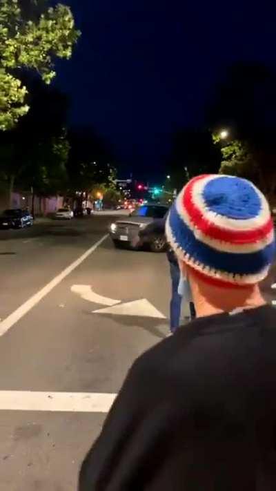 Car runs over rioter