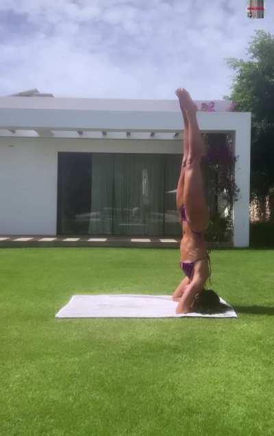 Doing yoga in a bikini. Look at those abs 😍