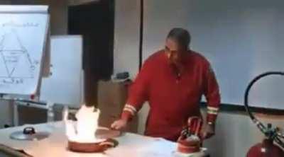 Firefighter demonstrating how to properly put out a pan fire