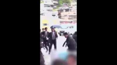 Bodyguard successfully protects Japanese Prime Minister Fumio Kishida against an unexpected smoke bomb attack during his speech