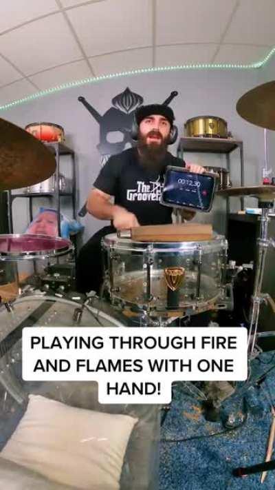 playing trough fire and flames with one hand on drums.(artist:elestepariosiberiano)