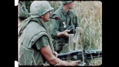 US Marine works his pipe and his M60 in Vietnam