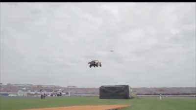 Driver Tanner Foust drops 90 feet down of orange track &amp;amp; soars 332 feet through the air .