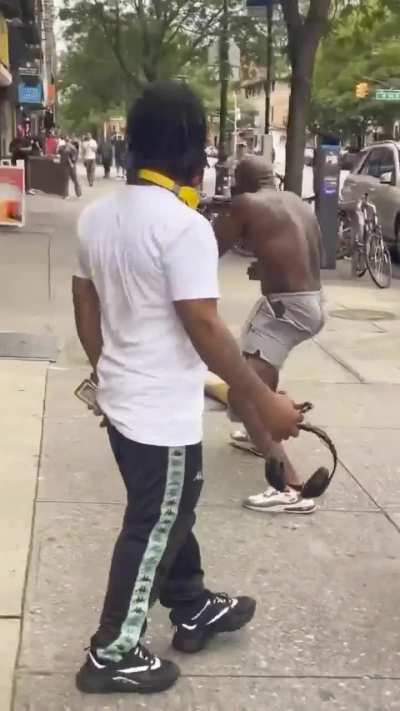 Shirtless man brawls with a man on the sidewalk