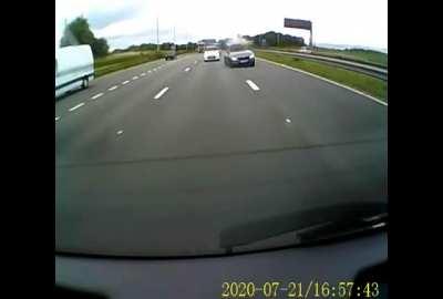 Car hits the central reservation and nearly takes me out.