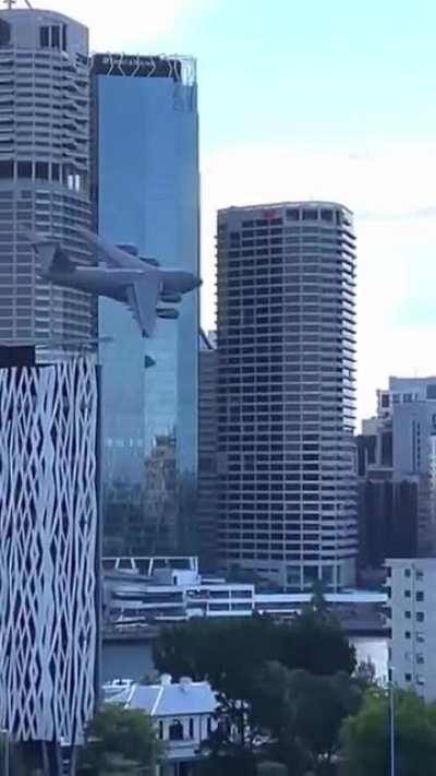 Flying a Boeing C-17 Globemaster through the middle of a city in Australia.