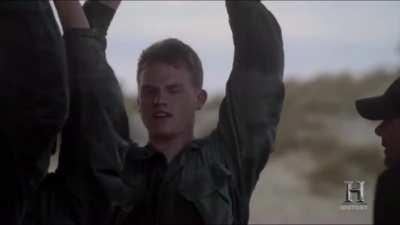 Former Navy Seal instructors providing encouraging words to a contestant on the selection whose never seen the ocean before.