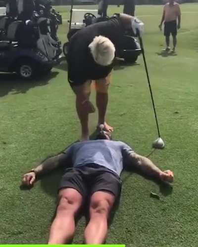 John Daly hits a drive off a Navy Seal
