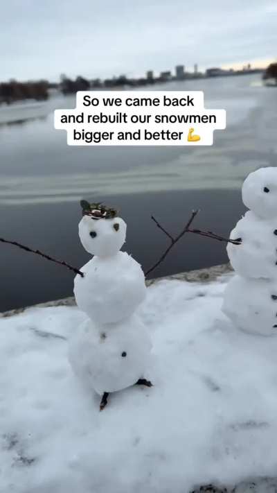 A bunch of people made a bunch of little snowmen on a bridge, and some guy knocks them all down