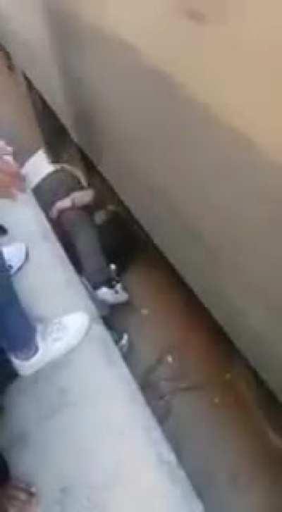 In Egypt, a father jumps onto the tracks to shield his child after she falls.