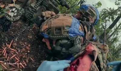 Ukrainian “Wolfpack elite soldiers of special unit A” engage Russian soldiers in a forest. Ukrainian soldier administers first aid to comrade with shoulder injury.