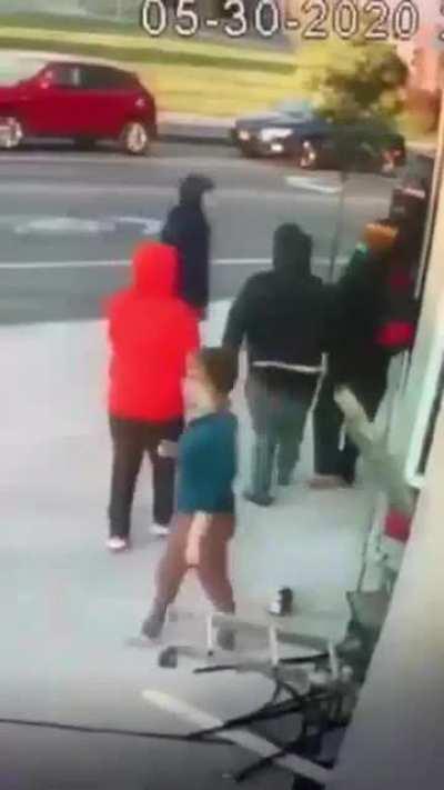 Small white woman trying to stop a BLM protester from destroying her business.