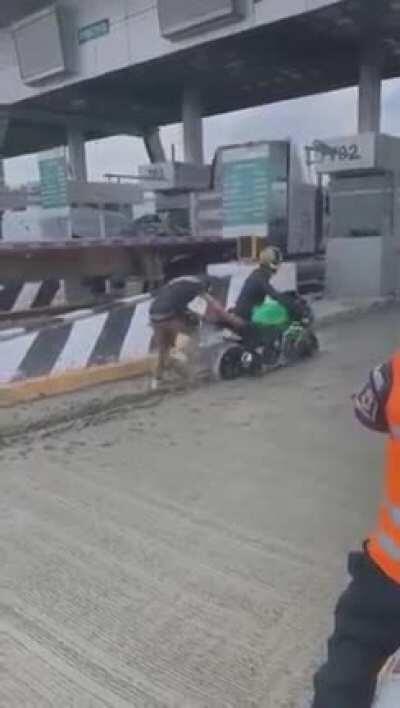 Idiot on a bike trying to avoid a toll