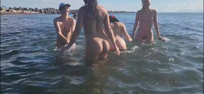 Dancing in the water at the nude beach with friends