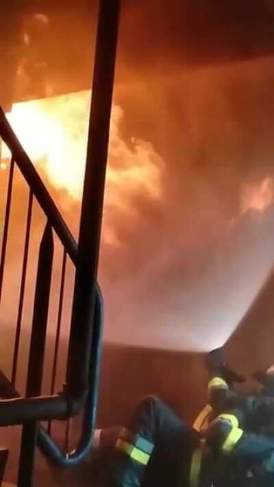 Firefighters battling a backdraft