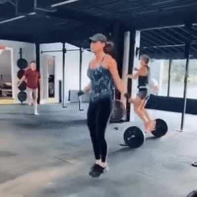 Trying to jump over a weight at gym