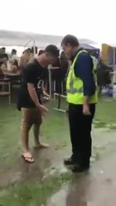 Man puts on flip flop by flip flopping.