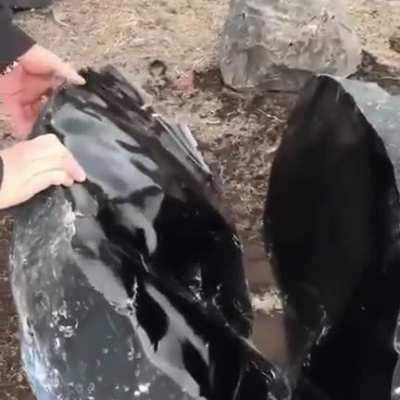 This is Obsidian, a naturally occurring volcanic glass It forms when lava, rich in silica, cools rapidly on contact with air or water.