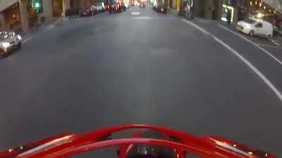 Motorcyclist gets hit by a car running a red light, flips in the air, and lands on his feet