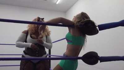 Giant heel provides a perfect example of how to use the ropes to pin her opponents arms and open up her stomach to be totally demolished