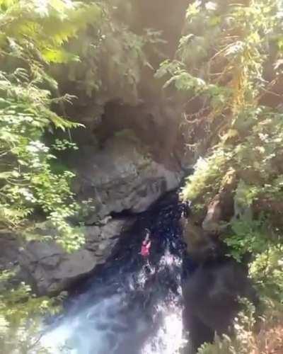 Flip dive off a cliff into a body of water