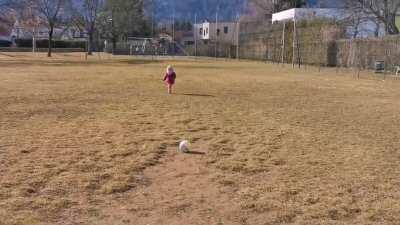Girl does a 50 meter run-up to kick a ball