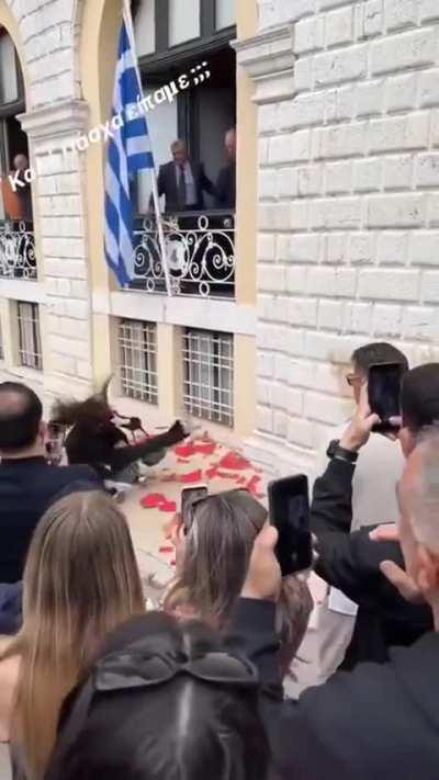 Tourists get in the way of a traditional Greek pot-smashing ceremony