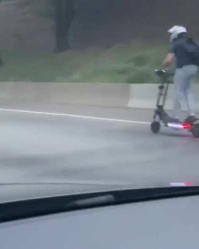 Guy on a scooter going 60 mph on the highway