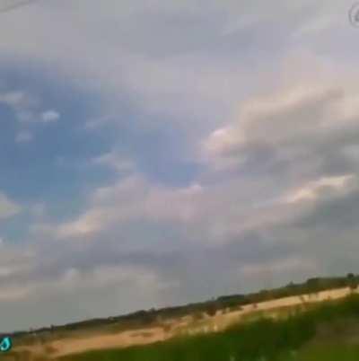 man throws rock with copper wire wrapped around it at power lines