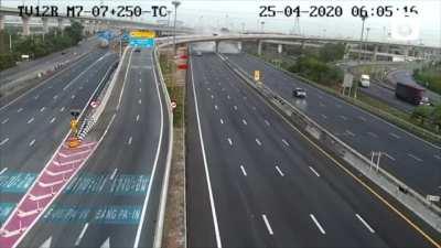 A speeding truck crashes off a flyover