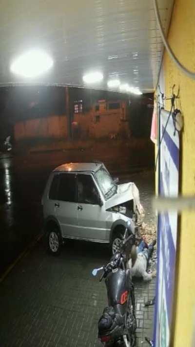 Car plows into a wall where a man happened to be standing.