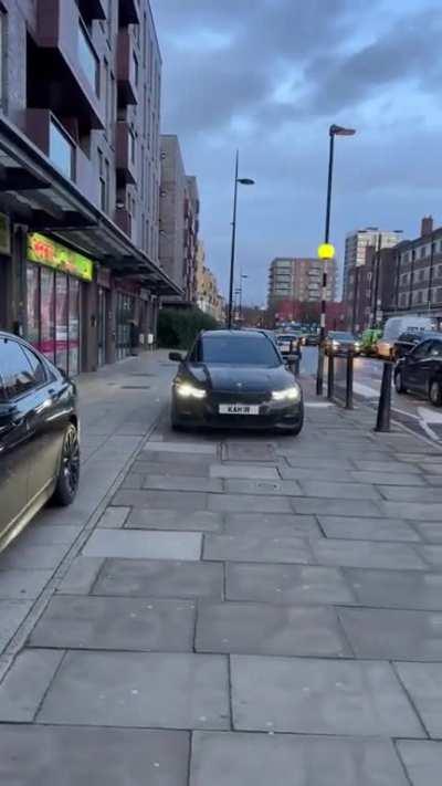 Driver uses the marked crosswalk to enter and drive on the sidewalk in London, UK