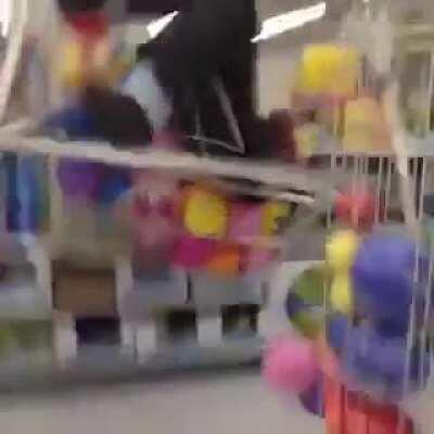 Man child dives into ball pit at a Walmart.