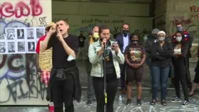 Speaker outside the Portland federal courthouse calls for the abolition of the police and the united states during a land acknowledgement