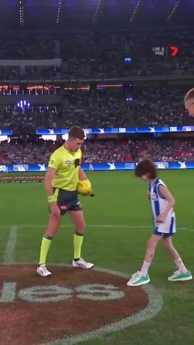 Sweetest footy fan ever tosses the coin on Good Friday