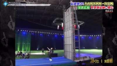 Throwing a little barrel over a wall.