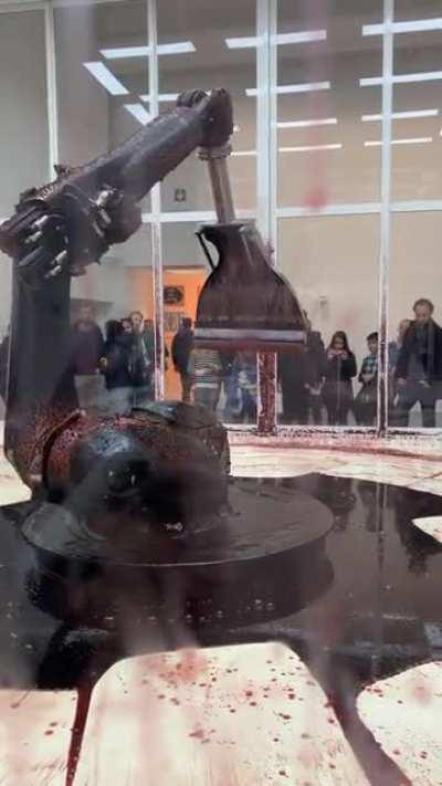 Как то жестоко. Арт инсталляция , робот пытается вернуть в себя жидкость ,но течь все равно его медленно убьет .