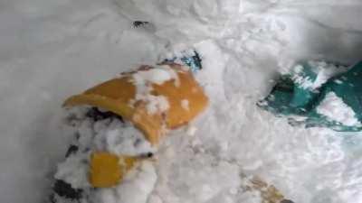 Skiier finds Snowboarder buried upside down while traversing down a mountain and rescues him