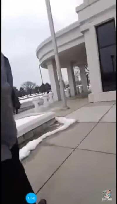 Man walks into police station, wearing a mask, and carrying an assault rifle.