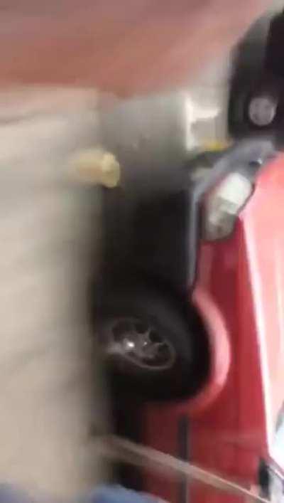 People watching a car in flames then BOOM