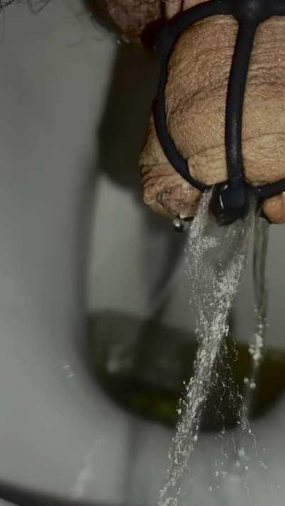 sausage in the cage and skewered with the plug. forced to piss