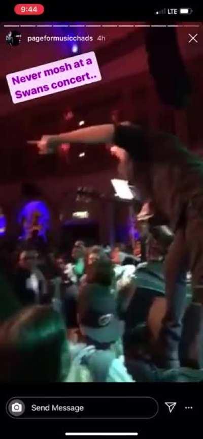 Michael grabbing a guy by the hair for moshing