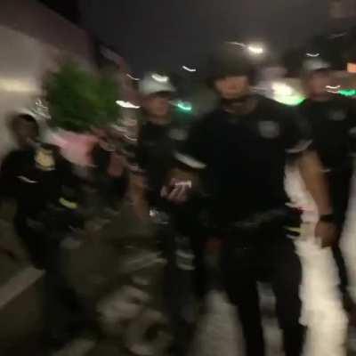 Police Officer having the time of his life threatens protestors with Pepper Spray