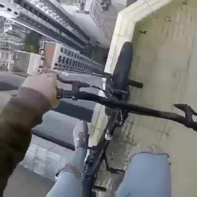 [Nihilist] Oleg Cricket balances on a BMX bike on the side of a building. (source video in comments)