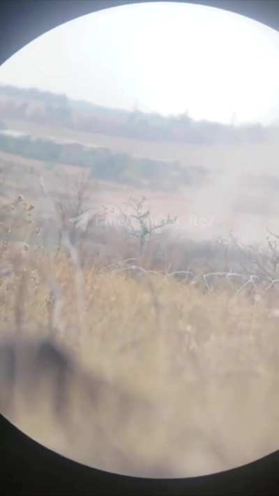 Ukrainian soldier narrowly avoids sniper fire while observing the front lines through binoculars. Sound at 0:09
